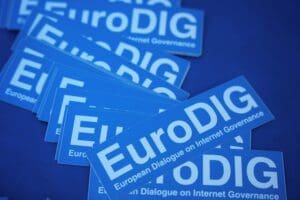 Pile of stickers on a table reading "EuroDIG European Dialogue on Internet Governance".