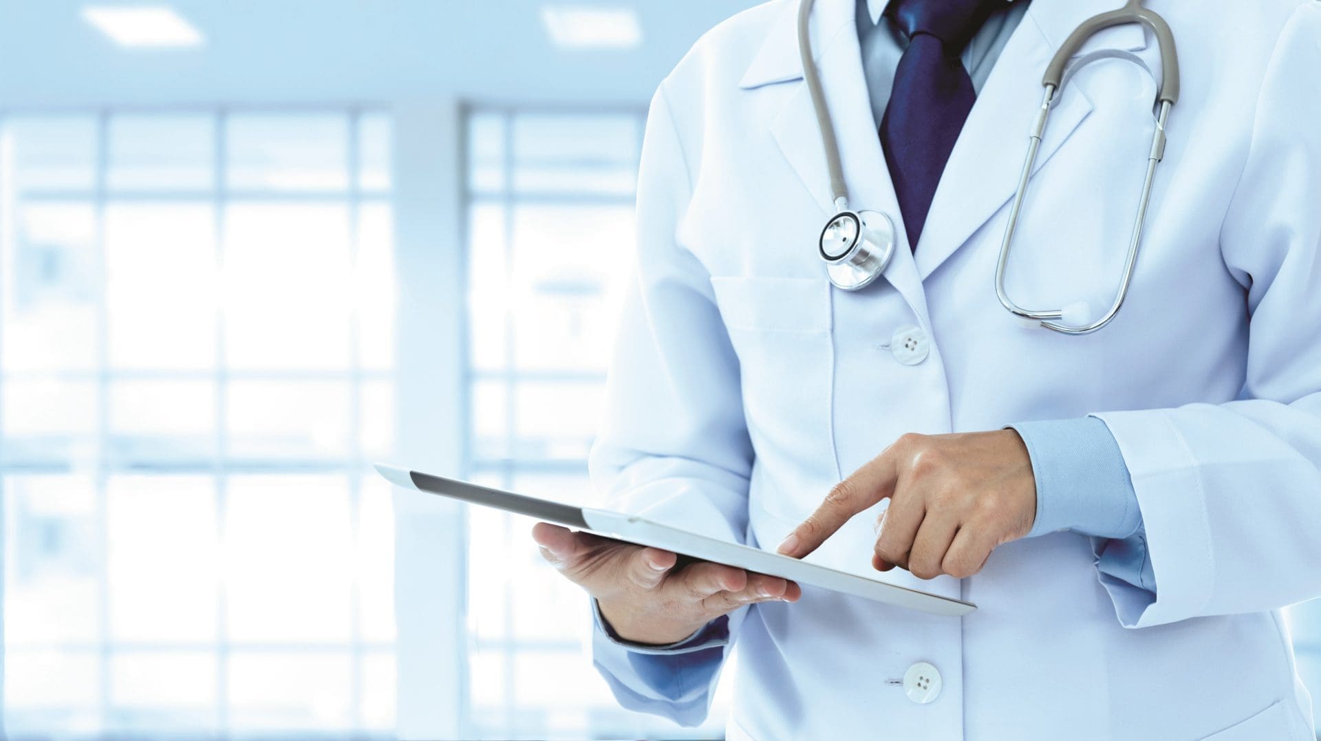 Photo of a doctor using a tablet.
