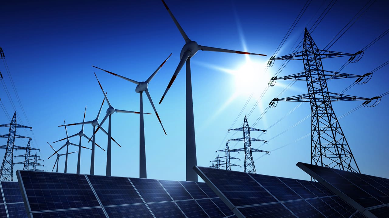 Renewable energy infrastructure: windmills, solar panels and power lines.