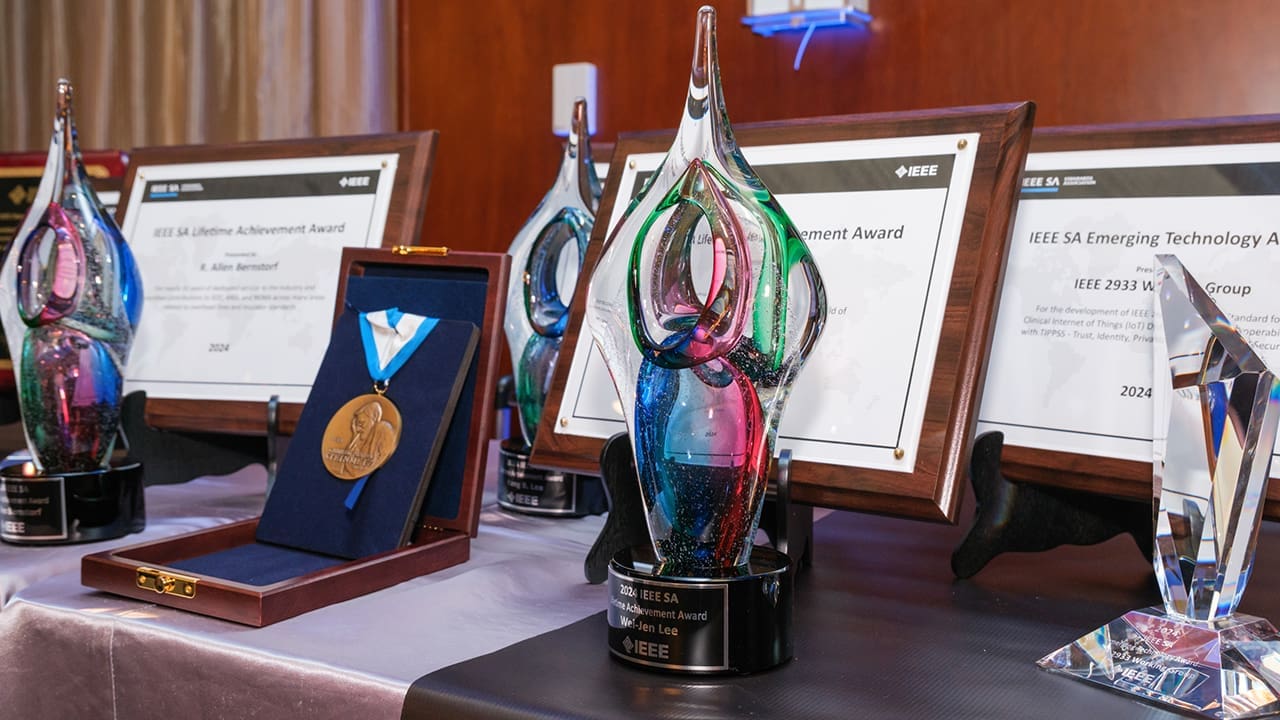 Multiple IEEE SA Awards sitting on a table.