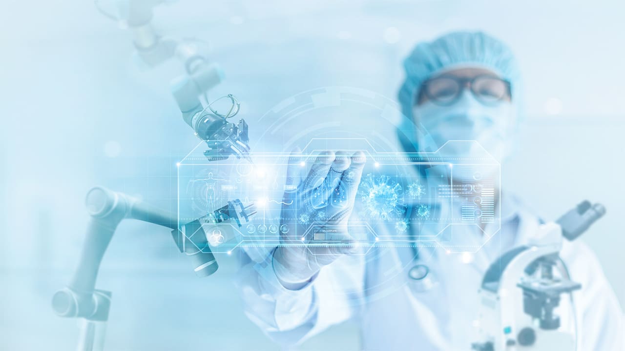 Doctor doing research in a laboratory, while pointing to something on a screen.