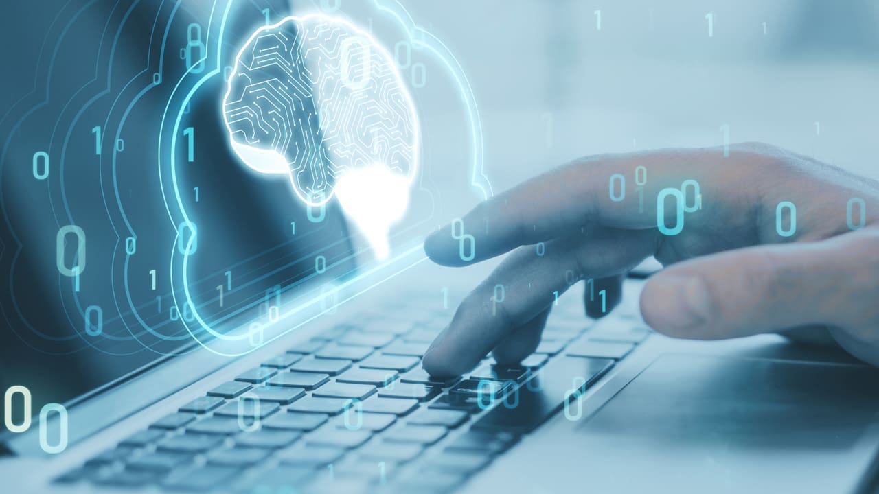 A laptop computer with a graphical representation of AI overlaid on top.