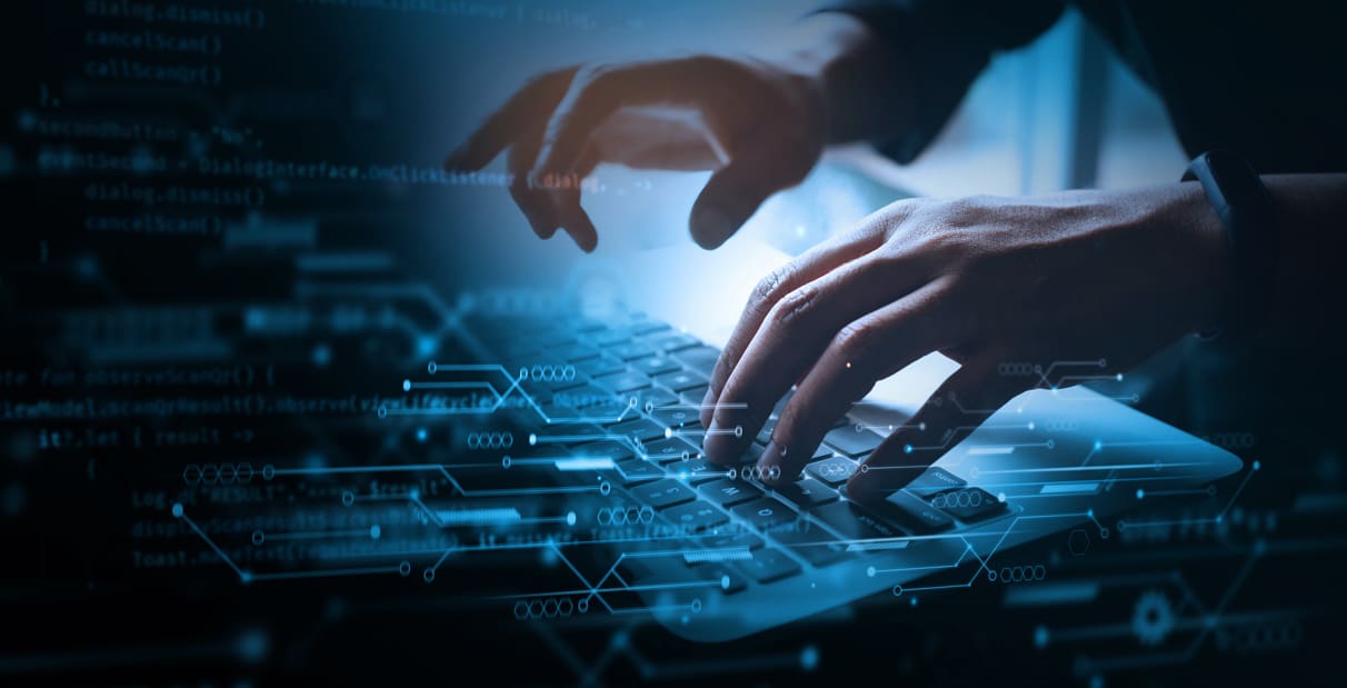 Person typing on keyboard.