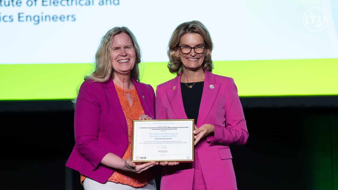 IEEE President Kathleen Kramer receiving a certificate of recognition on stage at WSIS Forum 2025.